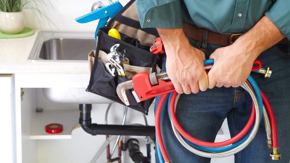 plumber holding tools